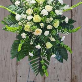 White and pale green floral standing spray on an easel