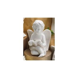 White angel figurine holding an open book