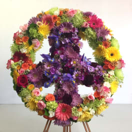 Large floral wreath in a cross shape with multicolored flowers