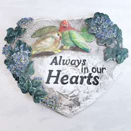Heart-shaped memorial plaque with two birds and blue flowers