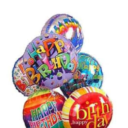Cluster of colorful birthday balloons with printed messages