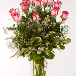 Pink roses arranged in a clear glass vase