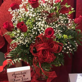 Red rose bouquet with baby's breath and a red ribbon bow
