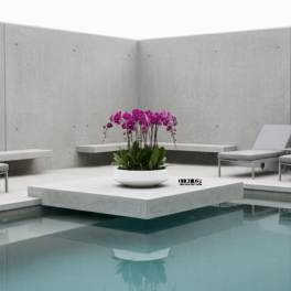 Pink orchid arrangement in a white bowl beside a pool