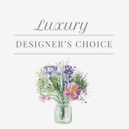 Mixed bouquet in a glass jar vase with pastel purple and pink flowers
