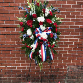 Standing patriotic floral wreath with red, white, and blue ribbons
