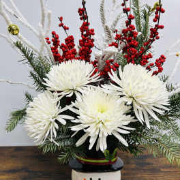 White chrysanthemum arrangement in a snowman vase with red berries