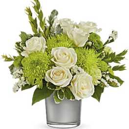 White roses and green mums arranged in a clear glass vase