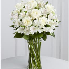 White roses and alstroemeria in a clear glass vase