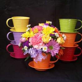 Colorful bouquet in stacked teacup-shaped containers