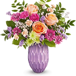 Peach and pink roses with purple flowers in a lavender vase