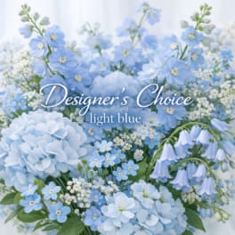 Light blue floral arrangement with hydrangeas and small blue blossoms