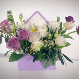 Purple and white mixed flower arrangement in a lavender box