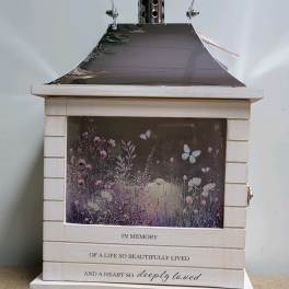 White memorial lantern with floral artwork and an engraved sympathy message