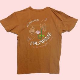 Brown graphic T-shirt with a floral hand illustration and text