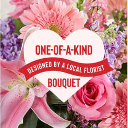 Pink and purple bouquet with a heart-shaped sign reading one-of-a-kind bouquet
