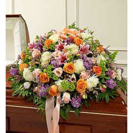 Large floral casket spray with orange, pink, white, and purple blooms