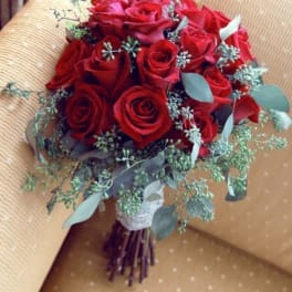 Bouquet of red roses with eucalyptus and small filler flowers