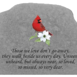 Gray memorial stone with a red cardinal and white flower
