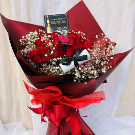 Red rose bouquet with baby's breath and a graduation card