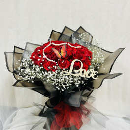 Red rose bouquet with baby's breath, pearl garland, and a Love sign