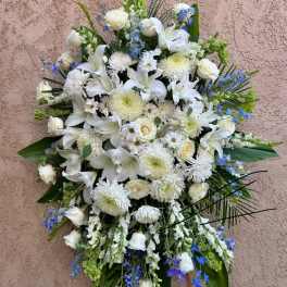 Large white funeral spray with lilies and chrysanthemums