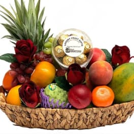 Fruit basket with roses and a box of chocolates