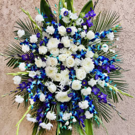 Large blue, white, and purple floral standing spray