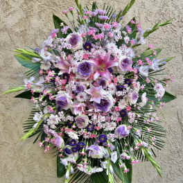 Large standing floral spray with pink and lavender blooms