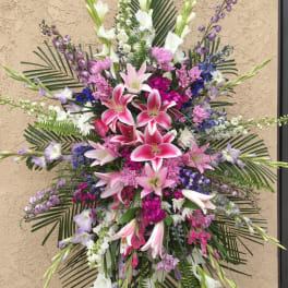 Large standing floral spray with pink lilies and purple-white flowers