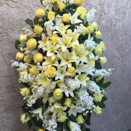 Standing floral spray with yellow roses and white lilies