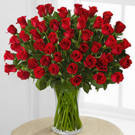 Large bouquet of red roses in a clear glass vase