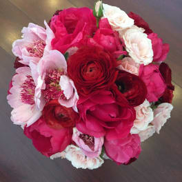 Round bouquet of pink, red, and white flowers