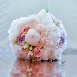 Round bouquet of pale pink, white, and lavender flowers