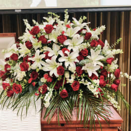 Large funeral spray of red roses and white lilies