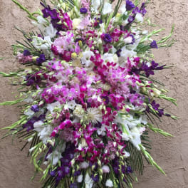 Large standing spray of purple, pink, and white flowers