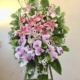 Standing floral spray with pink lilies and pale orchids