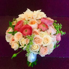 Bouquet of blush and cream flowers with a white wrap