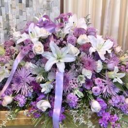 Large lavender and white floral spray with lilies and roses