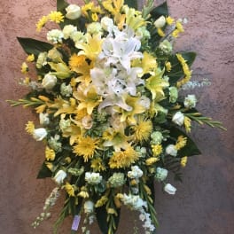 Yellow and white floral standing spray with lilies and roses