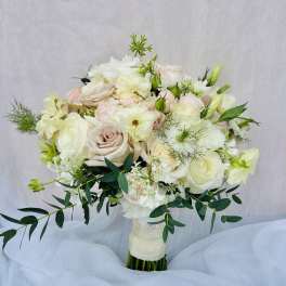 White and blush bouquet of roses and lisianthus with greenery