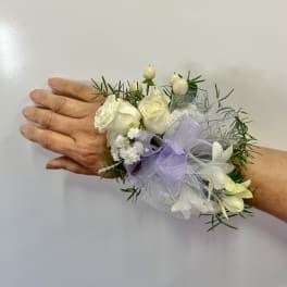 White rose wrist corsage with lavender ribbon and netting