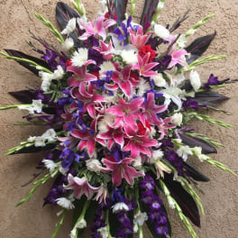 Large bouquet of pink lilies, white flowers, and purple blooms