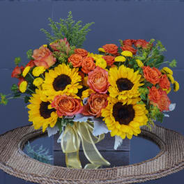 Sunflower and orange rose arrangement in a black box with ribbon