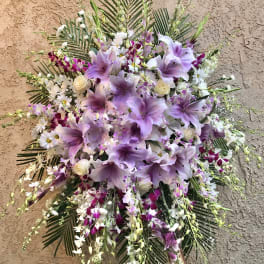 Large floral spray with lavender lilies and white orchids