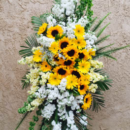 Standing floral spray with yellow sunflowers and white blooms