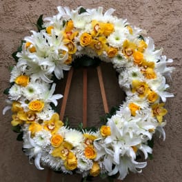 Yellow and white floral wreath on a stand