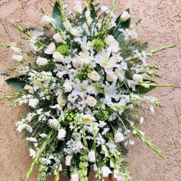 Large white floral spray with lilies, roses, and daisies