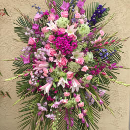 Large pink and purple floral spray with lilies and roses
