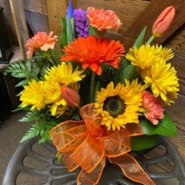 Bright mixed bouquet with sunflowers, gerbera daisies, tulips, and a purple accent flower